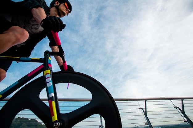 Free photo man ride a bicycle at bridgethe image of cyclist in motion on the background in the morning