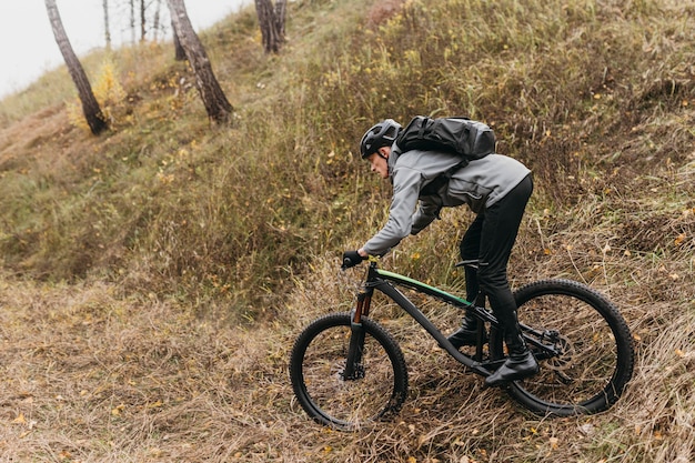 Man riding a bike on mountain path