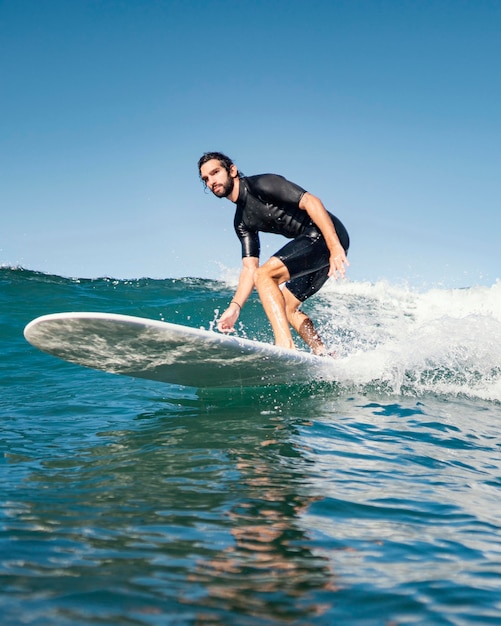 Man riding his surfboard and having a good time