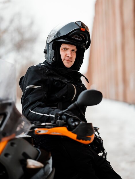 Man riding motorcycle on winter day