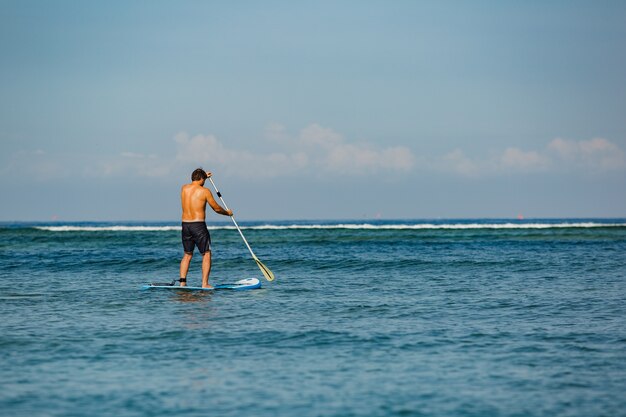 Man riding sup. 