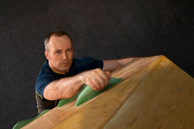 Man rock climbing indoors in the arena