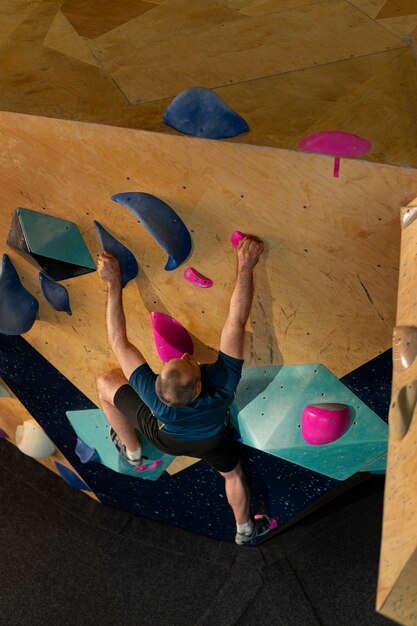 Man rock climbing indoors in the arena