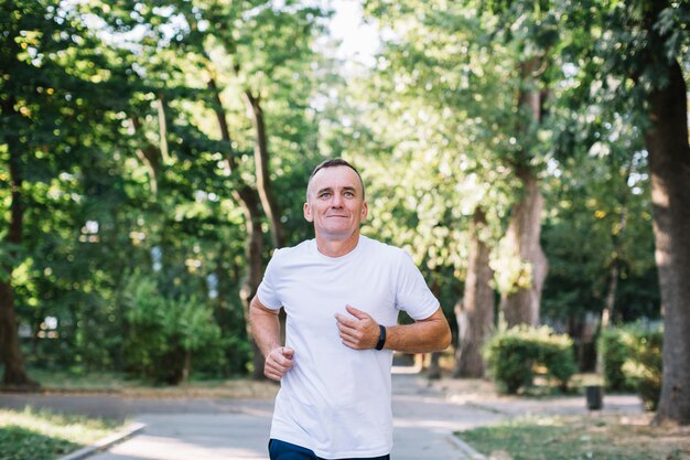 Man running on an alley in the park