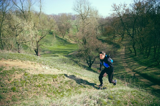 Man running in a park or forest against trees