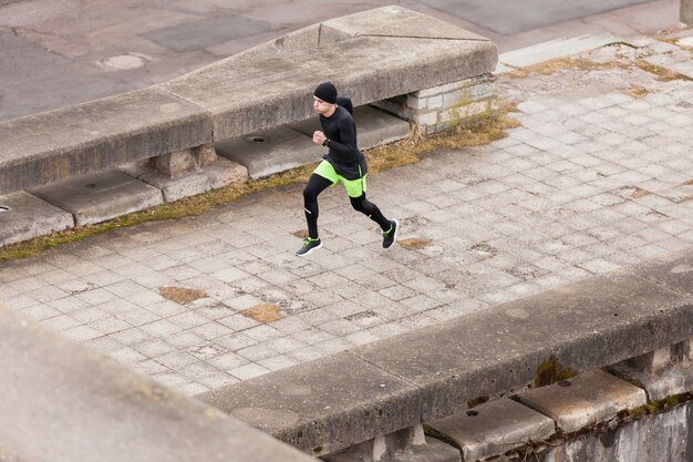 Man running in rainy city