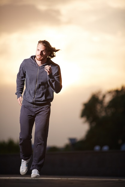 Man running at sunset