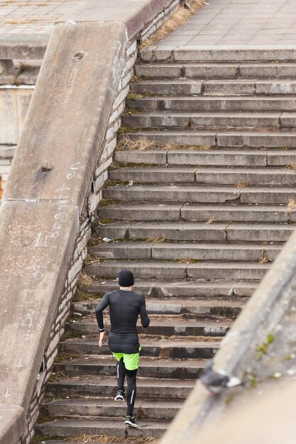 Man running up concrete stairs