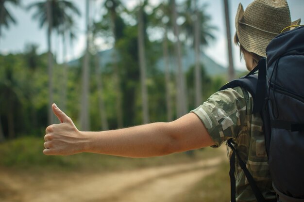 Man's hand catches the machine hitchhiking