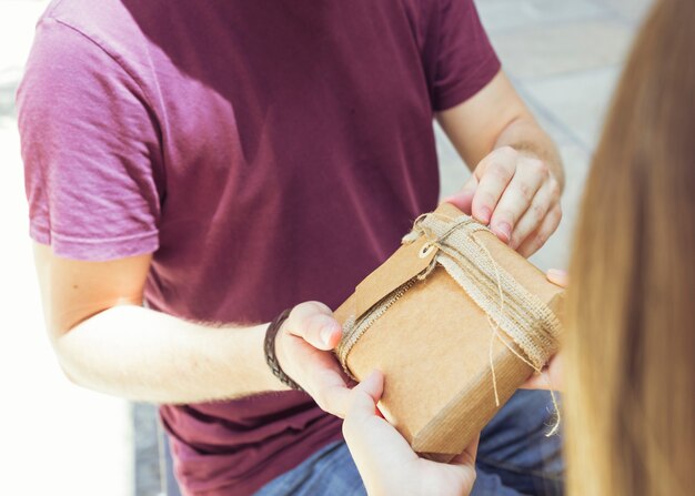 Man's hand giving gift to his girlfriend