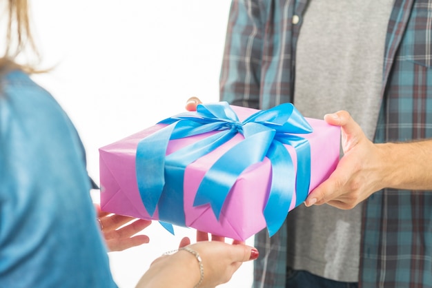 Man's hand giving valentine gift to his girlfriend