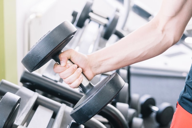 Man's hand with dumbbell