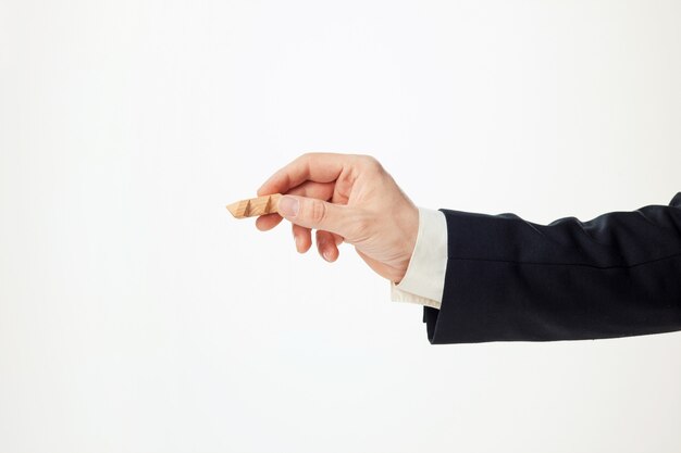 Man's hands holding wooden puzzle.