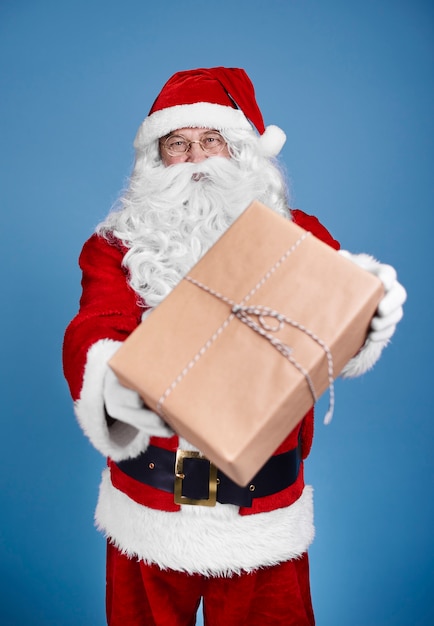 Man in santa claus costume giving christmas presents