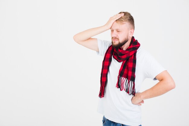 Man in scarf having headache