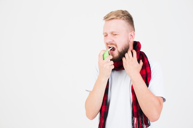 Man in scarf using spray