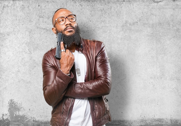 Man scratching his face with a gun