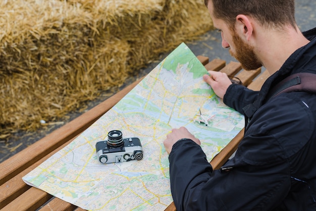 Free photo man searching route on map