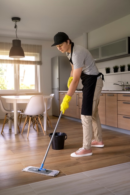 Free photo man servant cleaning the house