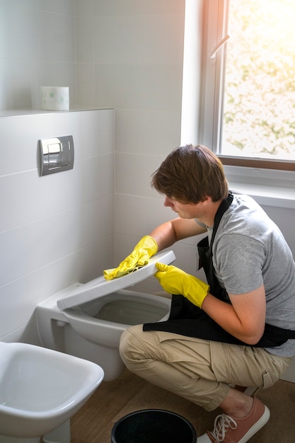 Free photo man servant cleaning the house