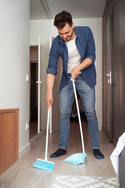 Free photo man servant doing chores around the house