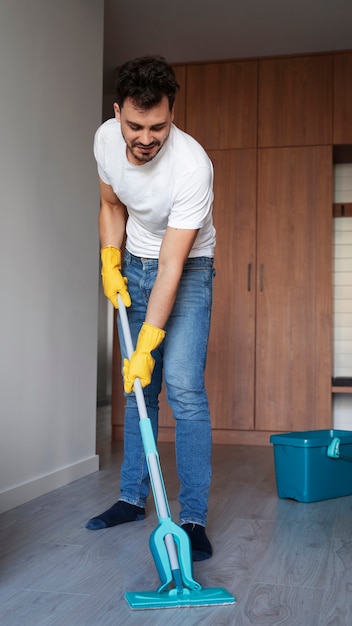 Free photo man servant doing chores around the house