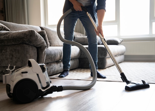 Free photo man servant doing chores around the house