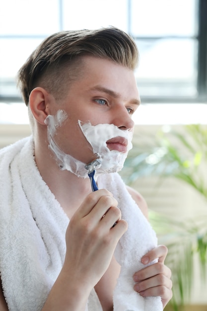 Man shaving his beard