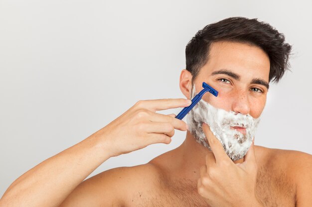 Man shaving with razor