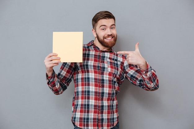 Free photo man in shirt holding blank board