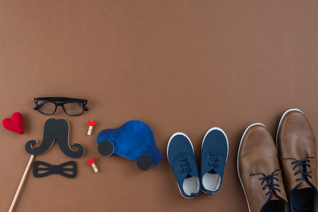 Man shoes with glasses and paper mustache on table