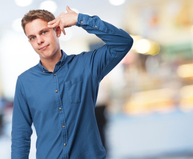 Man shooting his head with his hand