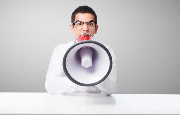 Free photo man shouting through a megaphone