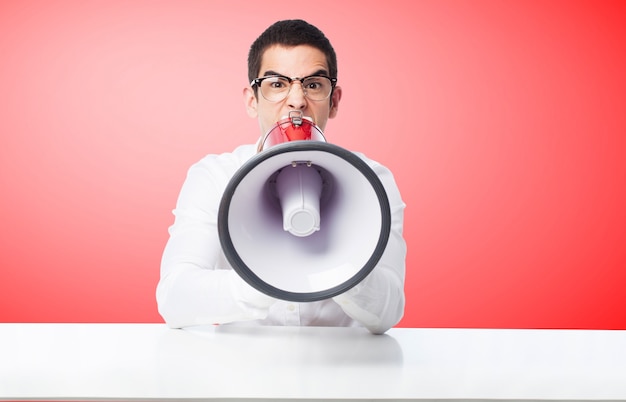 Free photo man shouting through a megaphone