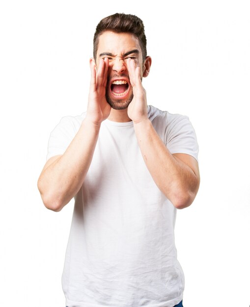 Man shouting with hands on face