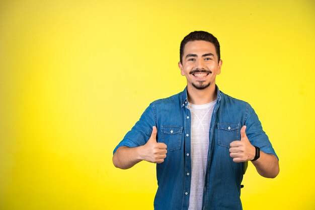 Man showing both thumbs up as a manner of satisfaction