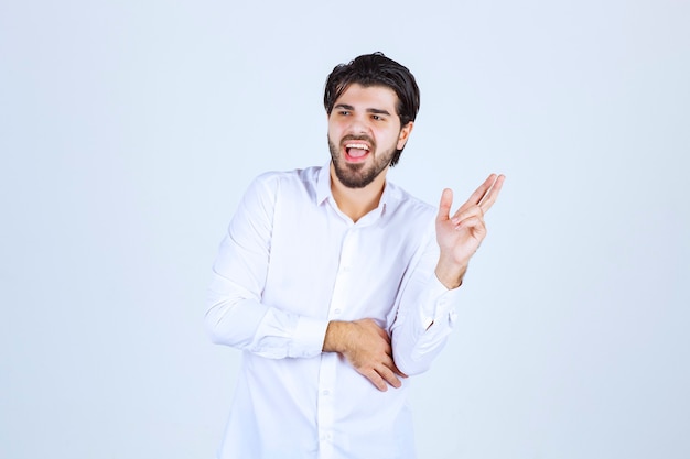 Man showing finger cross sign and swearing