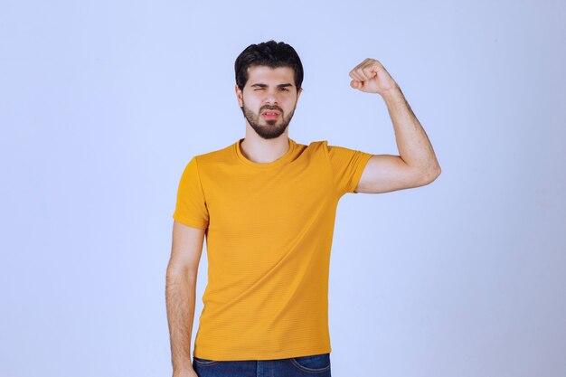 Man showing his arm muscles and feels powerful.