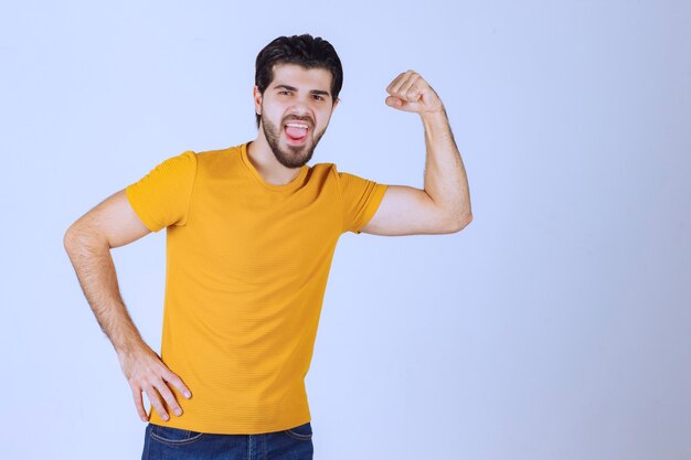 Man showing his arm muscles and feels powerful.