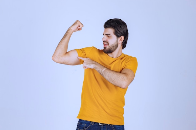 Man showing his arm muscles and feels powerful.