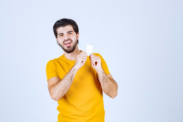 Man showing his business card and presenting himself with a confidence.