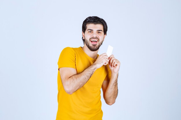 Man showing his business card and presenting himself with a confidence.