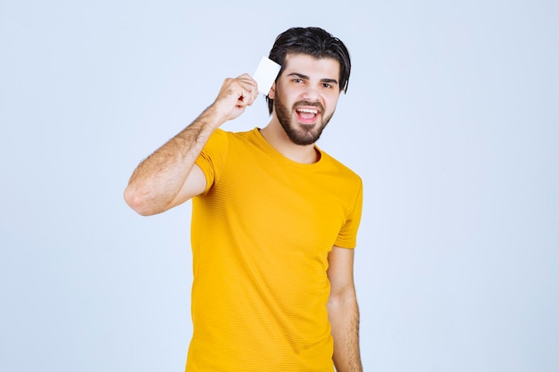 Man showing his business card and presenting himself with a confidence.