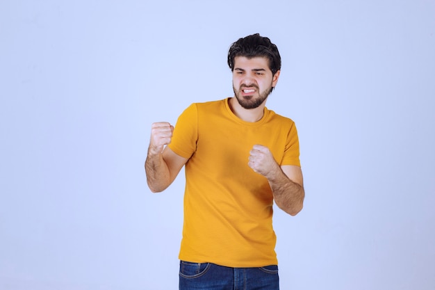 Man showing his fist and arm muscles