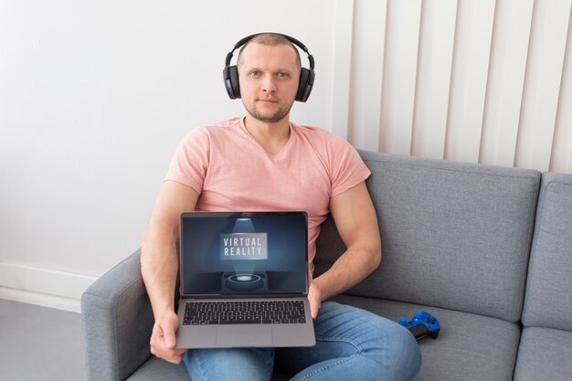 Man showing his laptop for videogames