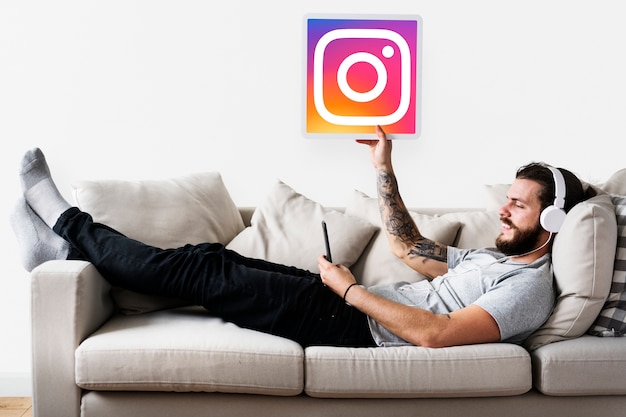 Free photo man showing an instagram icon