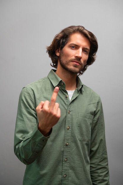 Free photo man showing middle finger gesture