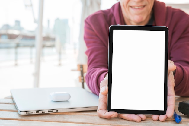 Man showing new digital tablet with blank white screen