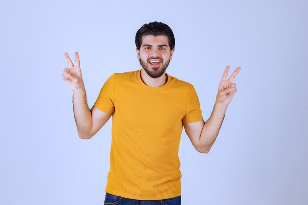 Man showing peace and friendship sign in the hand.