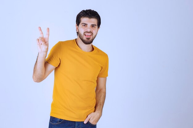 Man showing peace and friendship sign in the hand.